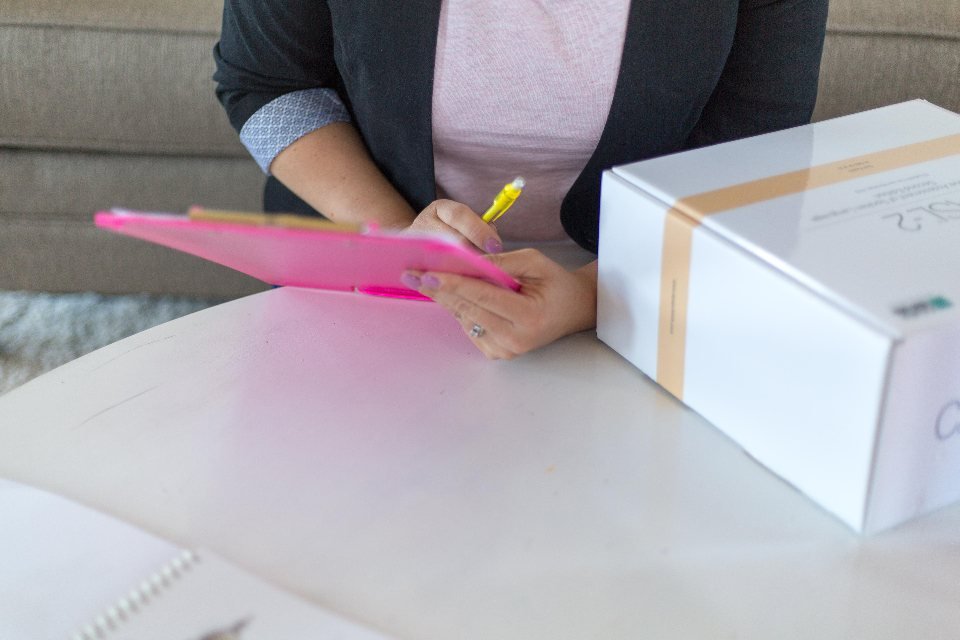 Homeowner filling out a project readiness checklist on a clipboard before requesting estimates