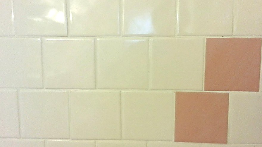 Restored white grout lines on wall tile showing how to clean grout back to a like-new color